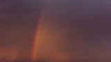 Regenboog met onweer